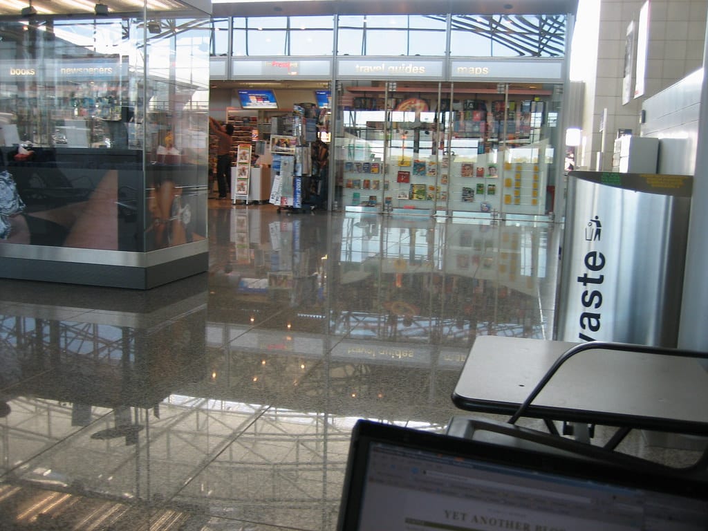Travelers with luggage inside an airport terminal