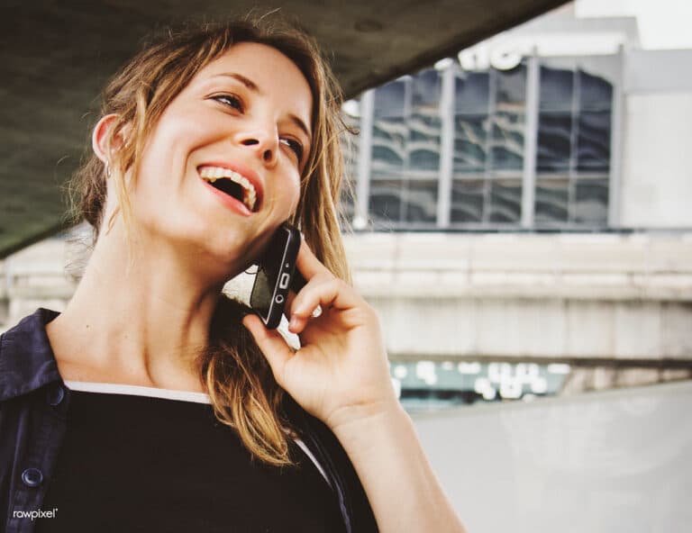 A woman smiling while talking on the phone