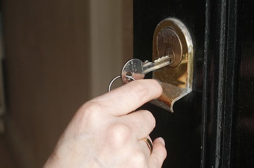 A house key in a front door lock