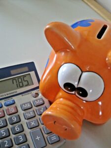 A calculator and piggy bank representing savings