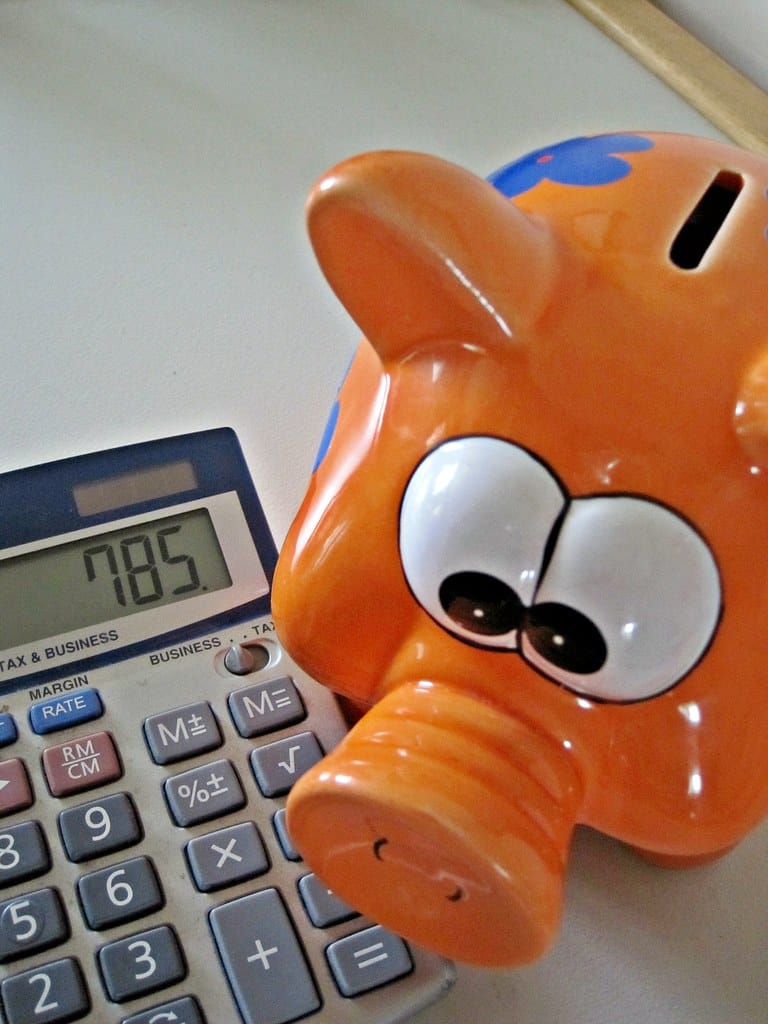 A calculator and piggy bank representing savings