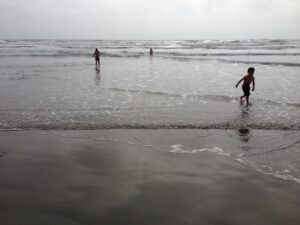 Kids playing on the sand at a Southern California beach