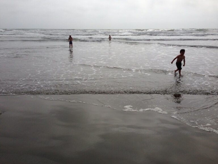 Kids playing on the sand at a Southern California beach