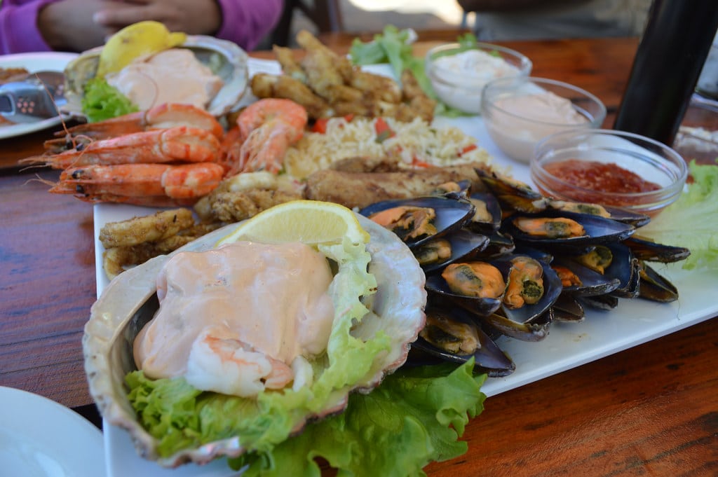 A seafood platter served at a beachfront restaurant table
