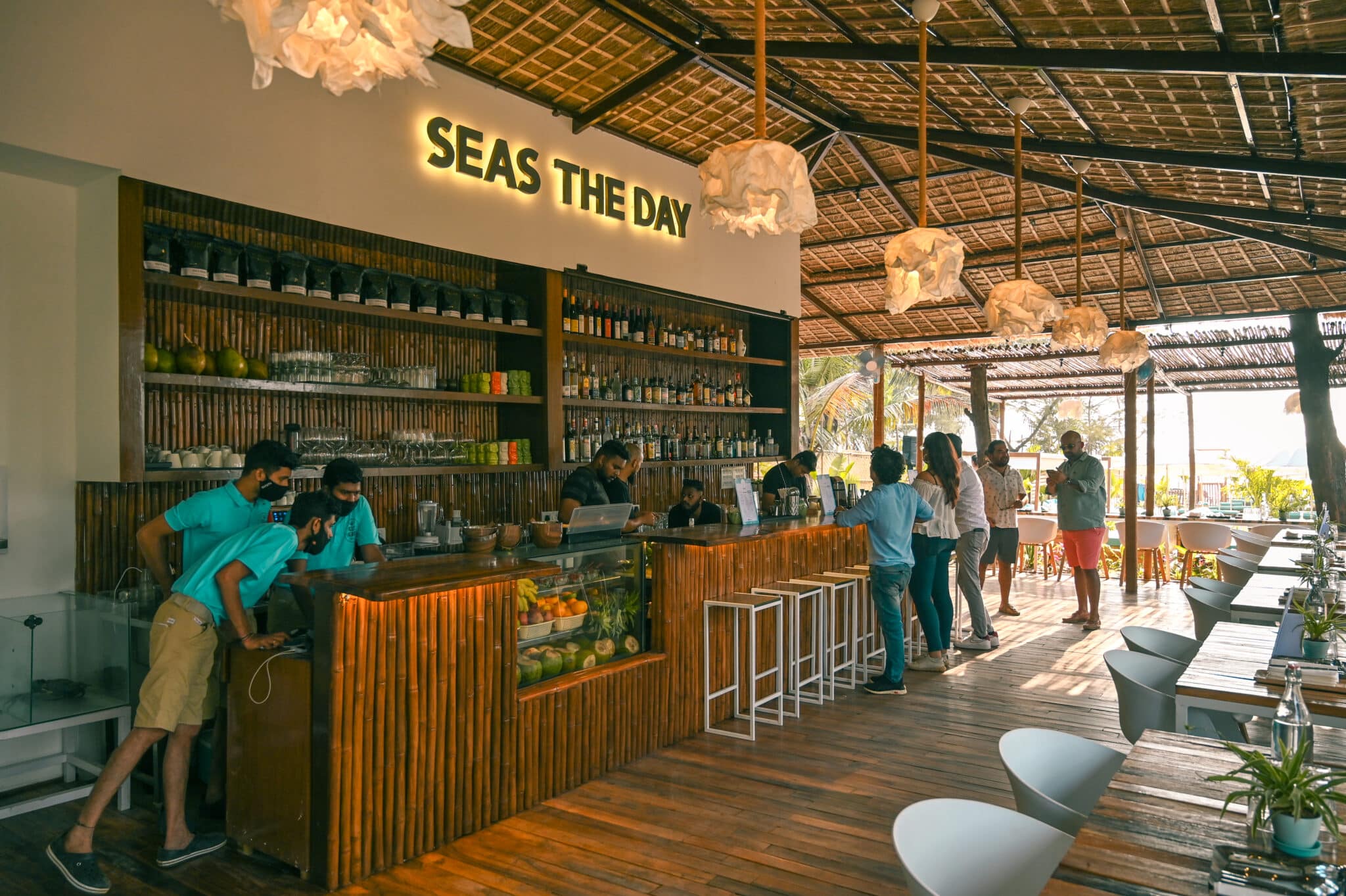 Dimly lit tiki bar interior with tropical decor and craft cocktails